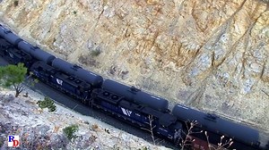 From the Camera of Scott Hiddelston, an amazing shot of upgrade coal loads and a downgrade mixed freight at Iron Ridge Cut on Mullan Pass. Check out Scott's drone footage of this scene on YouTube! From the BKVP show, 2 discs on DVD or Blu-ray "Montana Rail Link, Mullan Pass & Beyond" https://rfd.video/Mullan | Railfan Depot