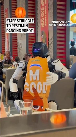 Staff struggle to restrain dancing robot