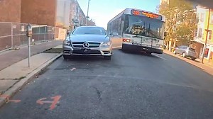 Careless Mercedes driver loses door to passing bus