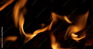log of wood on fire. log in a burning fireplace close-up. make a fire in a fireplace. wood log fire background. close-up of flame from a fireplace fire