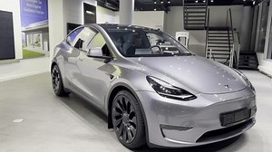 Tesla car model Y in liquid silver dubbed Mercury Silver Metallic color in Studio, electric vehicle in showroomr, alternative energy development concept, Elon Musk company, Frankfurt - January 2023