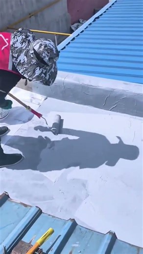 Coating a metal roof with grey waterproof paint using a roller #shorts