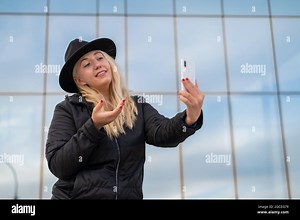 Deaf-mute young woman and speaks sign language over video communication on the phone outdoors Stock Photo - Alamy