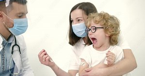Mother with kids vaccinating at pediatrician office