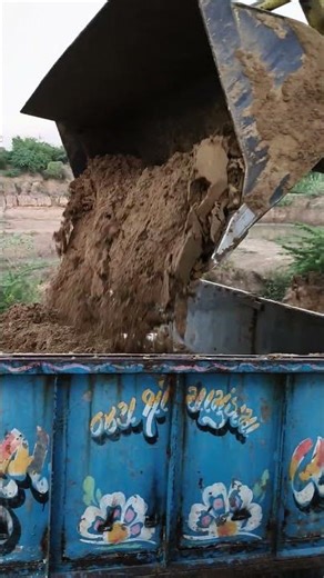 This image shows a tractor with a front loader attachment.The loader arm has it’s a 4-wheel-