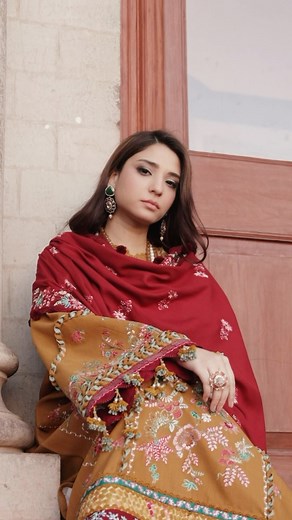 ‘Noemei’ - Luxury Shawl Unstitched Collection. Code: D2-A A three panelled mustard shirt unfolds, decked in resplendent allure and graced by the presence of intricate floral motifs engraved onto a radiant tapestry of mustard khaddar. Masterpiece unfolds, adorned with the artistry of satin stitches with intricate floral multi colored embroidery with acrylic shawl, elevated to extraordinary heights by a daring and swirling four sided floral embroidery adorned with vivid hues. Shirt: Khaddar Trouse