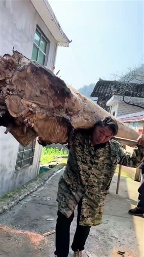 "The Art of Carrying a Log: Strength, Balance & Tradition"