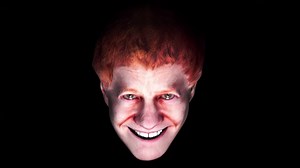 The Disembodied Digital Head of Danny Elfman Sings About Being 'Happy' in a Really Spooky Music Video