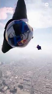 Wingsuit flyers perform daring between-tower stunt
