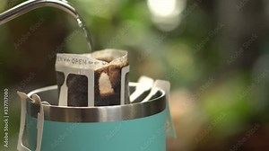 How to making coffee drip with hot water, roasted coffee beans on filter, Hot water pouring to roasted coffee for fresh drip coffee. Industrial food and drink concept.