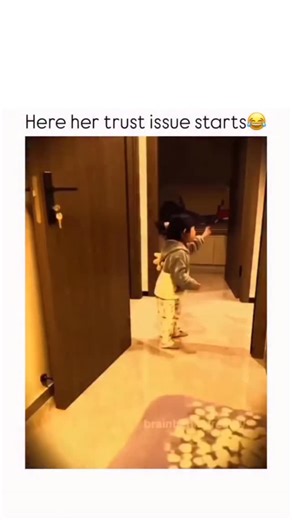 Dozen on Instagram: "In this heartwarming video, a toddler girl with a high ponytail and wearing a cozy grey and white hoodie is seen playing a joyful game of tag or hide-and-seek with an adult in a hallway. The scene begins with her excitedly running toward the camera, her face lit up with a bright, wide smile and a contagious laugh. She playfully claps her hands and interacts with the adult, who is partially visible in a white sweatshirt and dark pants, as they gently chase and engage with her
