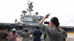 Sailors' family members waved farewell to the USS Ronald Reagan. Nearly 400 sailors in their dress whites manned the aircraft carrier's rails as the aircraft carrier steamed out of Tokyo Bay on its final deployment from Japan. | Stars and Stripes