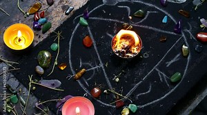 Black magic ritual background with magical altar, candles, crystals and herbs. Sorcerer rite of witchcraft and occultism. Halloween occult, esoteric and divination concept.