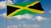 Drapeau de la Jamaïque sur fond de nuages flottants sur le ciel bleu