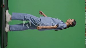 Full Body Of Side View Asian Female Doctor With Stethoscope Walking On Green Screen Background In The Hospital