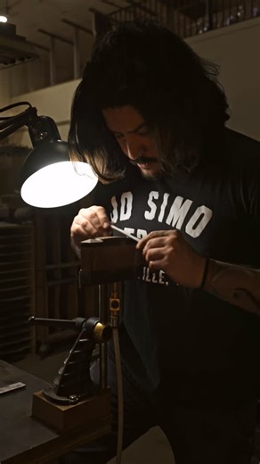 Collings Guitars on Instagram: "Longtime team member Carlos hand sands and preps an ebony pyramid bridge for one of our 12-fret flat tops, paying special attention to maintaining the clean lines and smooth curves of this iconic shape. The passion and dedication of our luthiers is at the heart of what makes Collings instruments consistently inspiring to pick up, admire, and play, each one handmade here at our shop in Austin, Texas. #handcrafted #atx #collingsguitars"
