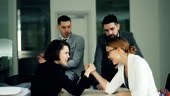 Cute girls office workers are competing in arm wrestling sitting in...
