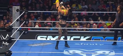 Mia Yim deserves all the credit in the world for saving this spot. It’s obvious Rhea was having a hard time lifting Mia over her head with those functional muscles so I’m glad Mia had enough ring awareness to use the ropes for leverage.