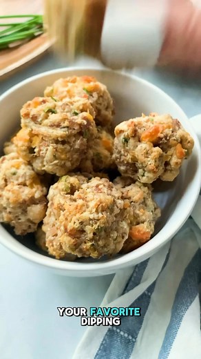 5 ingredient Cream Cheese Sausage Balls ready in under 30 minutes! 😍🙌 Ingredients ▢ 1 pound ground spicy sausage ▢ 1/2 pound cream cheese, softened ▢ 2 cups Bisquick baking mix ▢ 1 cup shredded cheddar cheese ▢ 1/4 cup chopped fresh chives Instructions 1. Line two rimmed baking sheet trays with parchment paper. Set the trays aside. 2. Add the ground sausage and cream cheese to a large mixing bowl. Use your hands or a rubber spatula to mix the two ingredients together. Work the cream cheese int