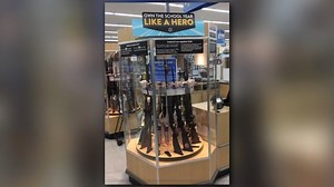 'Own the school year' sign above gun display in Walmart store