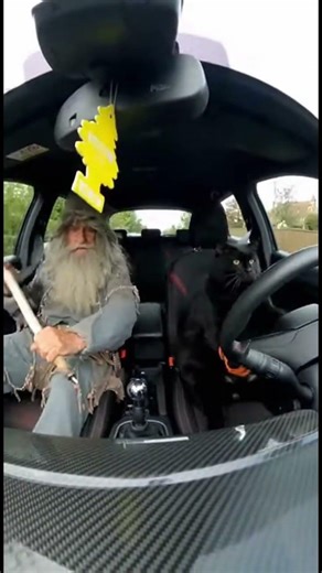 Cat Drives While Wizard Mumbles About the Machine God
