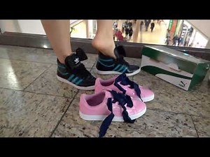 She is swapping shoes in a shopping centre
