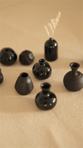 Collection of tiny black midfire clay pots: A ceramic miniature showcase