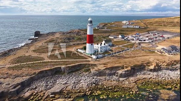 Aerial orbit of the iconic Portland Bill Lighthouse on the rocky Jurassic Coast, Dorset, UK.