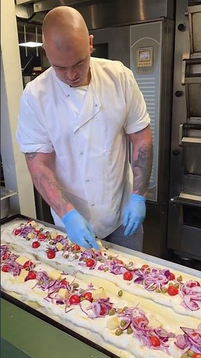 Garnishing Italian Focaccia Bread for the Oven. Streetfood of London