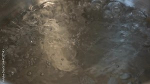 Boiling Water, Boiling Water Bubbles, Macro, Slow Motion. Water Boils in a Saucepan, Close-up. Cooking Food. The Process Of Boiling Water.