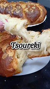 Tsoureki is a traditional Greek sweet bread, typically associated with Easter but enjoyed year-round. This soft, braided loaf is known for its rich, sweet flavor and fragrant aroma. Makes 2 large loaves Ingredients: 270g sugar 175g unsalted butter 250ml milk -------------------- 2 x 11g yeast 250ml warm water 2 tablespoons sugar -------------------- 4 eggs 1300g plain flour or all-purpose Zest of 2 oranges 4g mastic (ground) 5 g mahlepi (ground) ----------------- 1 egg 3 tbsp milk Almond slivers