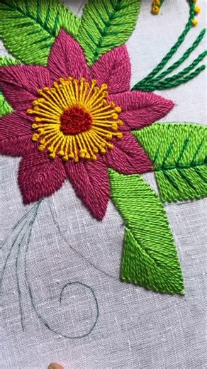 Whisper Thread on Instagram: "Main Flower & Stitching Details 🧵 At the heart of this design lies a stunning, oversized flower in vibrant shades of pink and purple. Every petal and the central core have been crafted with exquisite precision! ✨ The Petals: To achieve that smooth, velvety, and dense texture, a meticulous Satin Stitch or Fishbone Stitch has been used. It truly brings the flower to life! 🎀 The Floral Center: The core features a brilliant yellow sunburst effect. At its very soul, yo