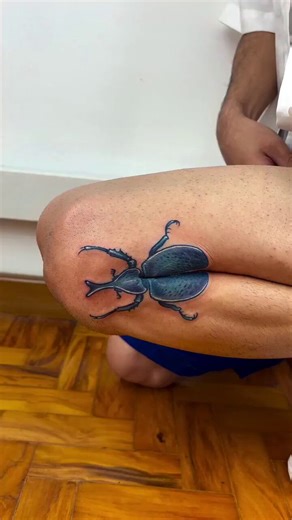This tattoo transforms when a leg opens, at the first time it looks like a cockroach but when leg opens it becomes a housefly