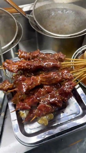 Freshly fried beef skewers with dipping sauce. Enjoy it?