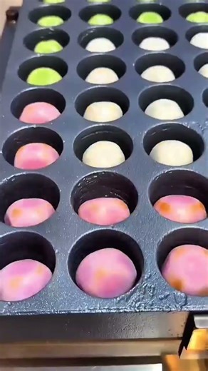 Hand placing dough balls into round mold tray