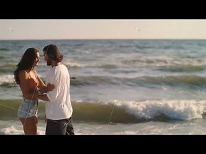Romantic Couple Kissing on a Beach in Slow Motion with Copy Space