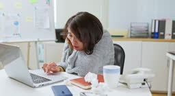 Asian woman sneezing chilly working