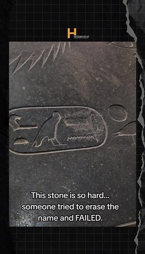 This is the pyramidion of Pharaoh Amenemhat III, one of the greatest rulers of Egypt's Middle Kingdom: This sacred capstone was designed to sit at the very peak of his pyramid at Dahshur, serving as the ultimate point of connection between the earth and the heavens. Carved from a single block of dark granite, its precise angles mirror the massive structure below. Originally, it would have been sheathed in electrum—a mix of gold and silver—catching the first and last light of each day to blaze li