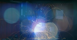 Animation of a welder at work with sparks and colourful spots of light in the foreground 4k