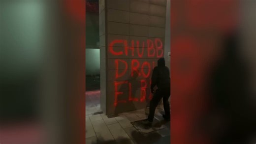 Activist plaster red paint on Chubb Insurance building