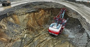Excavator digging in open pit mine. Stock clip