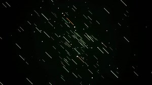 Abstract visualization of meteor shower. Animation. Meteor rain on the starry black sky background, seamless loop.