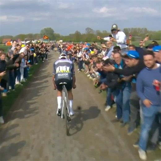 Spectator throws water bottle in Mathieu van der Poel's face at Paris-Roubaix. | NBC Sports Cycling