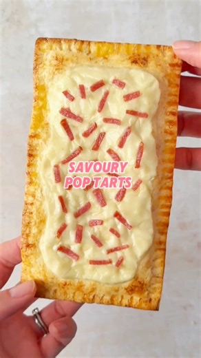 If you find Pop Tarts too sweet, try this homemade savoury version! Just slice a tortilla into rectangles, fill with cheese and tomato sauce, then seal the edges with a fork. Brush with egg, top with cheese and salami ‘sprinkles’, then bake until golden. Makes a delicious and fun snack or lunch! #poptarts #homemadepoptarts #savourypoptarts #funsnackideas #funlunchideas | The Fast Foodie