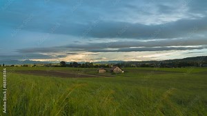Farm field with dense clouds and sunset. The clouds move over the field Stock Video