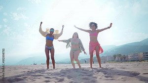 Beautiful multiethnic young women having fun on the beach during the summetime vacation. Storytelling representation of body positivity, self acceptance and individuality female concepts