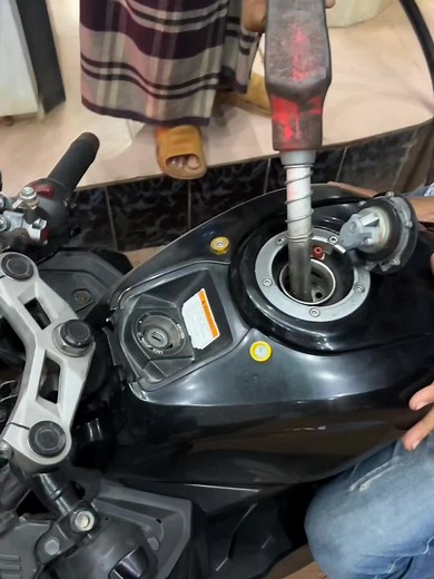 Nighttime Motorcycle Refueling at Fuel Stations