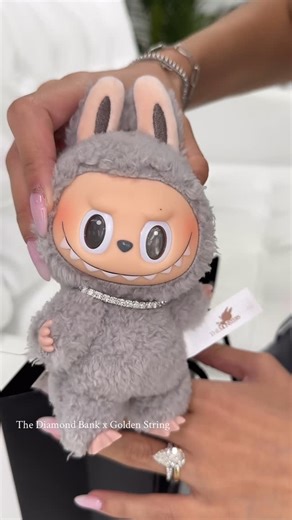 The Diamond Bank on Instagram: "You asked… we answered. FIRST ICED OUT LABUBU💎✨ Made this tennis chain for Sesame Bean Labubu 🫘 diamond tennis necklace with white or yellow gold DM US TO GET YOURS💛 #jewelrydesigner #thediamondbank #jewelgram #labubu #labubujewelry #labubucollection #labubuclothes #diamondlabubu #goldenstringjewelry"