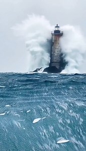 Storm Beacon⛯🌊🌩️ A weathered lighthouse stands against a raging storm as towering waves slam the rocks—one massive impact erupts into a wall of white water that briefly swallows the whole tower. Spray and droplets hit the lens while the rotating light cuts through rain and mist. AIvideo Turn the sound on for the deep roar of crashing waves, howling wind, distant thunder, and faint metal creaks. #Lighthouse #StormSea #OceanWaves #CinematicVideo #NaturePower | Rafael Nunes