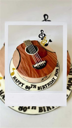 Guitar themed cake for an 80th birthday celebration 🎉 🎸 I really enjoyed making this cake! A 10” chocolate sponge cake with dark chocolate buttercream 😋 I created the wood effect top by combining a few different coloured browns with my fondant icing, rolling into strands, and then laying them flat on my work surface. I then twisted the fondant to get a nice effect and then rolled! The guitar strings are made from spaghetti which I painted with edible glitter. #guitar #cakemaking #cakemaker #c
